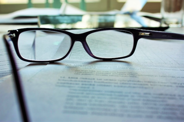 glasses set on top of a document on a desk